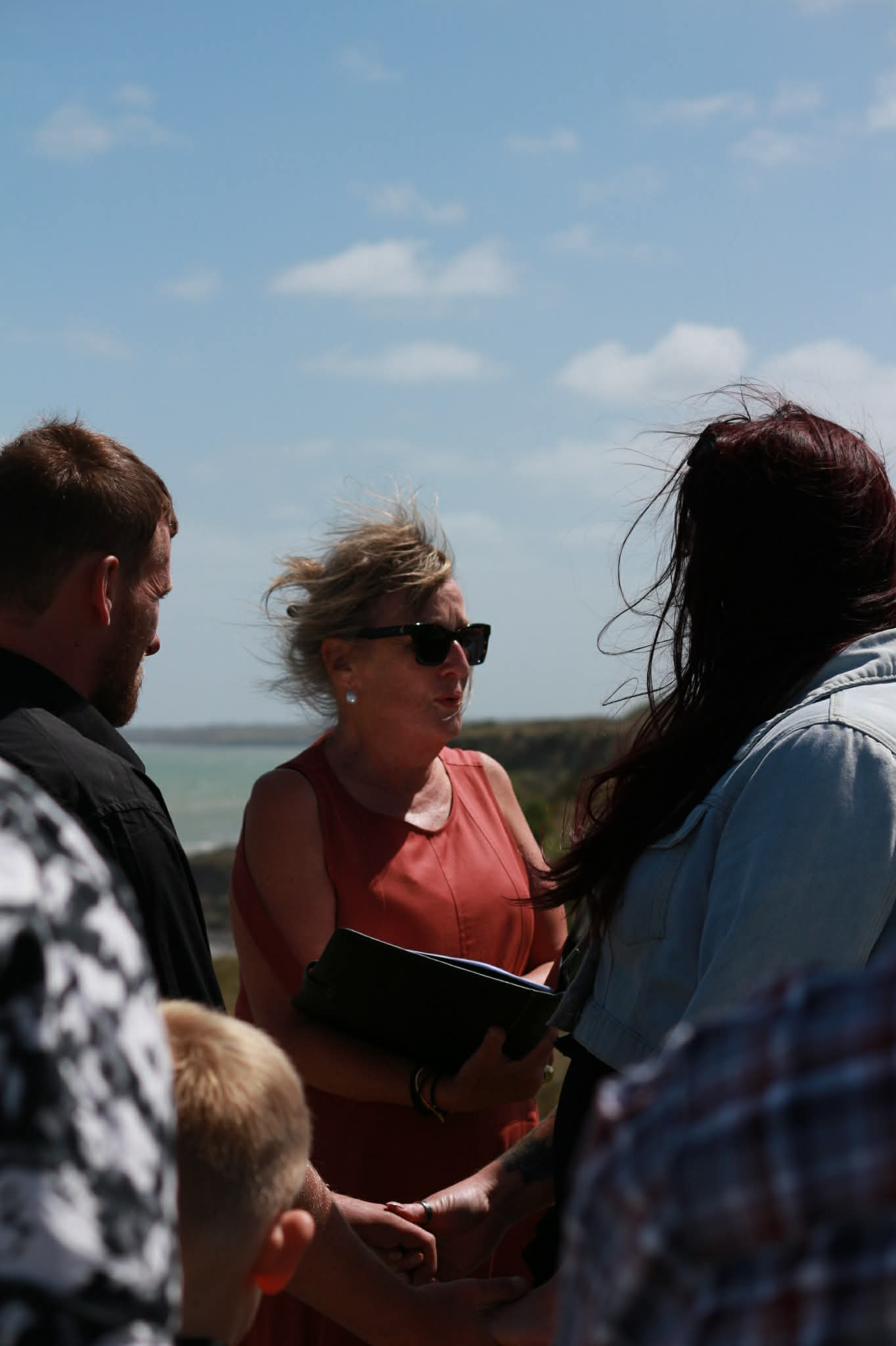Pauline officiating an outdoor wedding ceremony by the sea