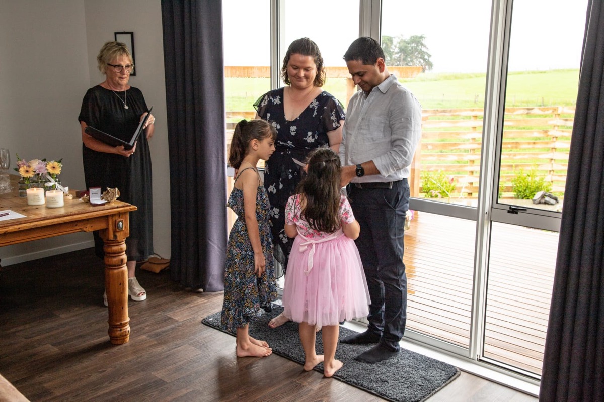 Pauline leading a small family wedding ceremony at home