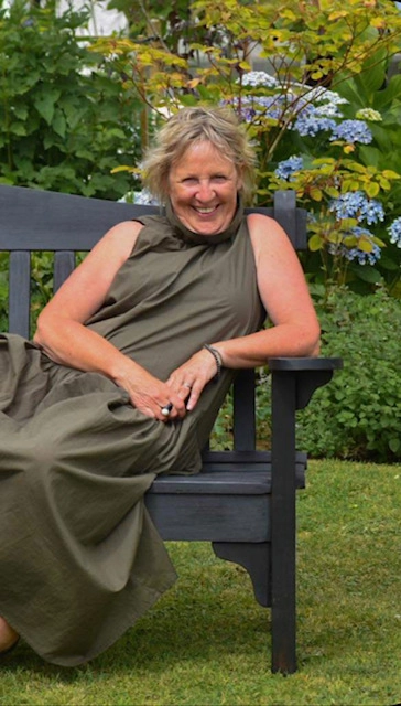 Pauline Humm-Johnson, Simplicite wedding celebrant, seated on a garden bench