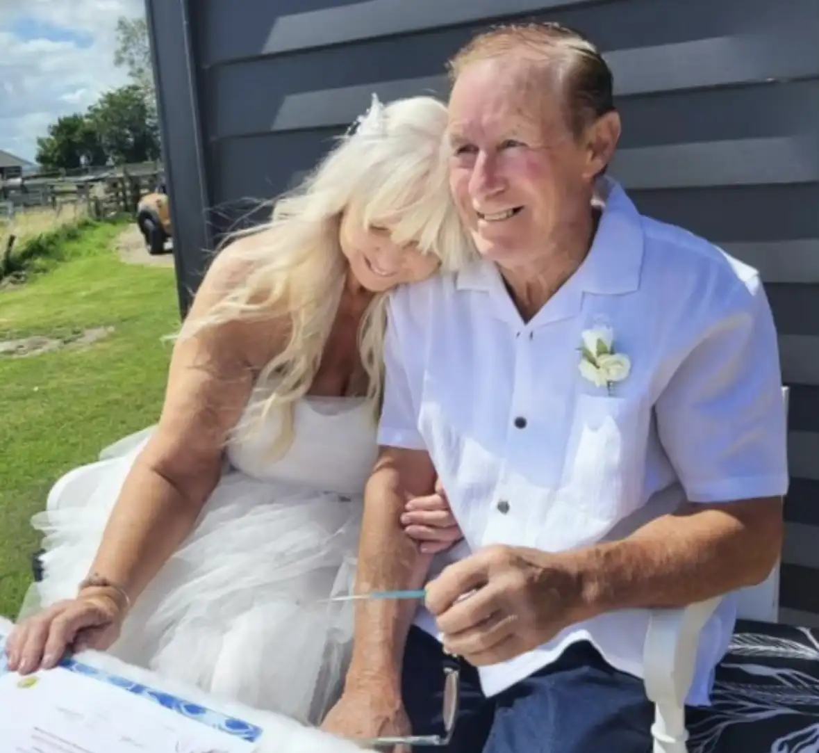 Bride and groom signing their vow renewal certificate