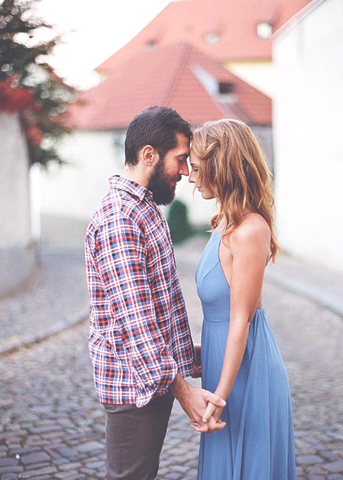 Couple embracing on a cobbled street
