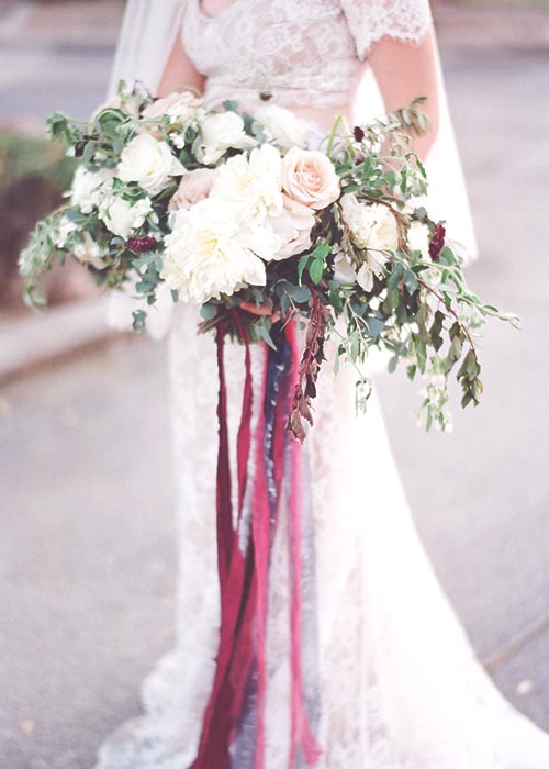 Bride holding a bouquet with trailing ribbons